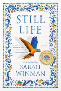 Book cover for Still Life by Sarah Winman, featuring a colorful parrot soaring across a white tile background with blue floral patterns and oranges—hinting at love in the air. Includes a book club selection badge and a quote praising the novel.