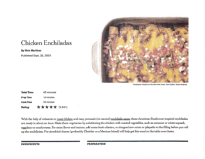 A baking dish filled with chicken enchiladas topped with melted cheese and herbs sits on a white surface, radiating a winter glow, with one enchilada partially served from the corner.