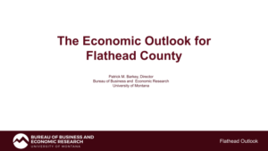 Title slide with text: The Economic Outlook for Flathead County by Patrick M. Barkey, Director, Bureau of Business and Economic Research, University of Montana. BBER logo and Flathead Outlook at the bottom highlight a seasonal spring focus.
