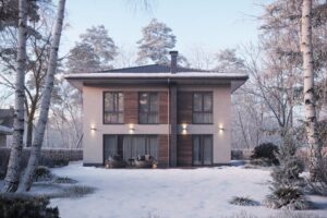 A modern two-story house with large windows and wood accents stands in a snowy yard, surrounded by bare trees. Two chairs sit on a small patio near the glass doors, as love in the air adds warmth to this calm, wintry scene.