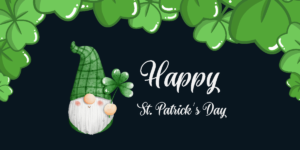 A festive St. Patrick's Day card featuring a gnome holding a shamrock, surrounded by green clovers, perfect for celebrating at the Spring Market or sending warm wishes from Flathead Valley.