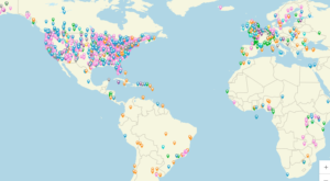 A world map showing thousands of multi-colored location pins densely clustered in North America and Europe highlights popular seasonal events during the Spring, with fewer pins in South America, Africa, and the Middle East. Most of Asia, Australia, and Africa have no pins.