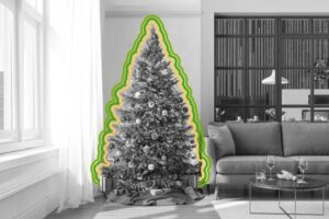 A decorated Christmas tree stands next to a sofa in a bright living room. Outlined with green and yellow lines, the black and white image features presents underneath and adds a touch of Merry Christmas cheer, perfect for the New Year season.