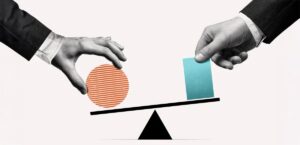 Two hands in suits balance a striped orange circle and a blue rectangle on a seesaw, illustrating equilibrium—perfect for symbolizing New Beginnings or celebrating June Joys as ideas or milestones are weighed and compared.
